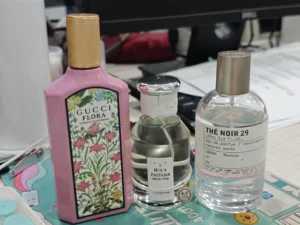 Close-up showing the difference in fragrance oil concentration between a luxury white floral perfume and a direct-to-consumer long-lasting dupe.