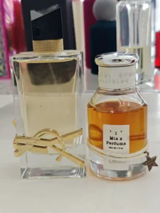 Side-by-side comparison of a $150 luxury designer perfume bottle and a high-quality, factory-direct affordable alternative.