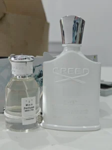 Side-by-side cost and packaging comparison between a $400 luxury designer perfume bottle and an affordable Creed Love in White dupe alternative.