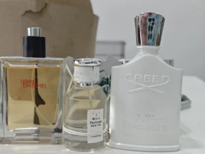 Laboratory formulation breakdown comparing the olfactory notes and ingredient quality of a high-end powdery white floral fragrance against a premium clone.