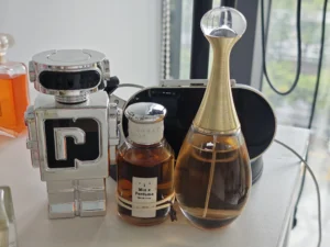 A premium Dior J'adore dupe bottle next to the original, highlighting the shared ylang-ylang and jasmine fragrance notes