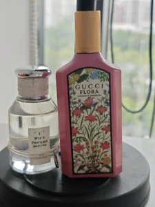 Side-by-side comparison of a luxury Gucci Flora Gorgeous Jasmine perfume bottle and a highly concentrated, long-lasting affordable dupe alternative.