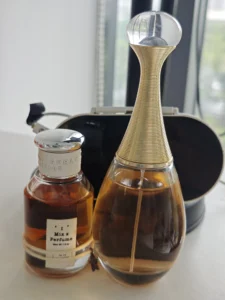 Side-by-side comparison of a luxury $150 designer floral perfume and a high-quality affordable Extrait de Parfum alternative