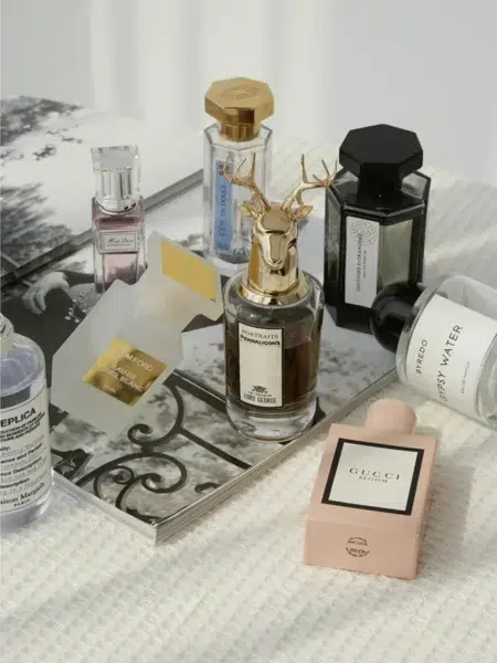 Side-by-side visual comparison of an expensive luxury designer perfume bottle next to a high-quality, affordable dupe fragrance alternative.
