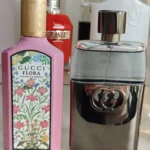Side-by-side comparison of a $150 luxury designer perfume bottle and a premium factory-direct Gucci Guilty dupe