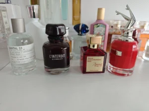 Visual comparison of a traditional luxury unisex perfume and a premium factory-direct fragrance alternative.