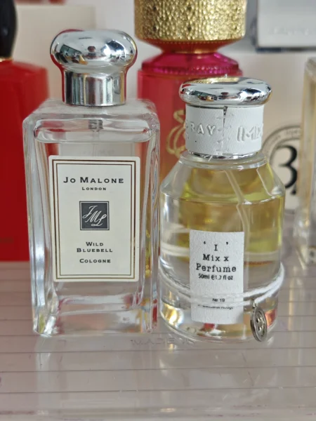 Side-by-side comparison of Jo Malone Wild Bluebell cologne and a high-concentration EDP alternative showing fragrance color differences.