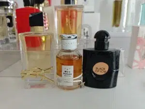 Comparing the retail luxury packaging of Mon Paris versus a highly concentrated, affordable fragrance dupe formulated for long-lasting wear.