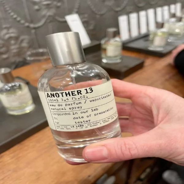Side-by-side packaging and cost comparison between a $300 luxury niche perfume and an affordable, factory-direct Another 13 alternative by Imixx Perfumes.