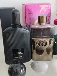 Side-by-side comparison of a traditional luxury designer perfume bottle and a high-concentration direct-to-consumer Black Orchid alternative in the USA.
