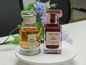 Side-by-side comparison of a luxury designer cherry perfume and a long-lasting affordable dupe alternative.
