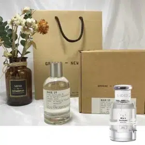 Clear glass perfume bottles comparing an expensive designer rain fragrance with an affordable, long-lasting juniper and patchouli scent alternative in the USA.