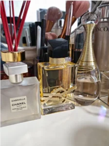 Side-by-side comparison of a luxury designer fragrance bottle and a high-quality affordable perfume alternative, showing the difference in packaging costs.