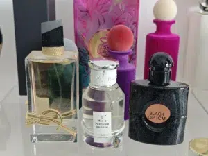 Side-by-side comparison of an expensive Yves Saint Laurent Libre perfume bottle and a high-quality, long-lasting factory-direct alternative.