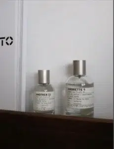 Side-by-side comparison of a traditional $300 luxury ambrette perfume and a high-concentration Extrait de Parfum alternative.