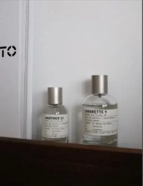 Side-by-side comparison of a traditional $300 luxury ambrette perfume and a high-concentration Extrait de Parfum alternative.
