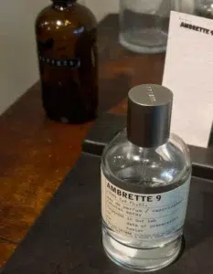 A visual breakdown comparing the packaging and juice color of a niche designer skin scent versus a direct-to-consumer ambrette 9 dupe.