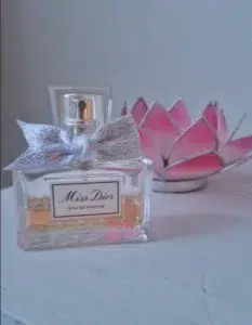 Side-by-side comparison of a $150 designer floral perfume and a high-quality affordable Miss Dior dupe by IMIXX Perfumes.