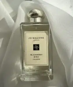 Visual breakdown of luxury fragrance costs versus direct-to-consumer perfume alternatives, comparing scent profiles and longevity of blackberry notes.