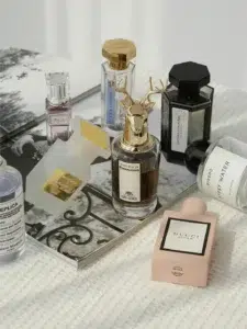 Side-by-side cost comparison of an expensive luxury designer perfume bottle and a high-quality affordable knock off perfume alternative.