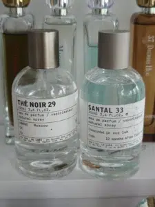 Side-by-side cost and concentration comparison of a $300 luxury Le Labo perfume and a high-quality factory-direct Extrait de Parfum alternative.