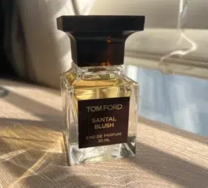 Side-by-side comparison of a $300 luxury designer sandalwood perfume bottle and an affordable premium Extrait alternative by Imixx Perfumes.
