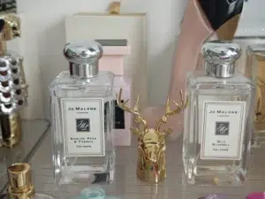 A side-by-side comparison of a traditional luxury wood sage and sea salt cologne and a high-concentration Eau de Parfum alternative.