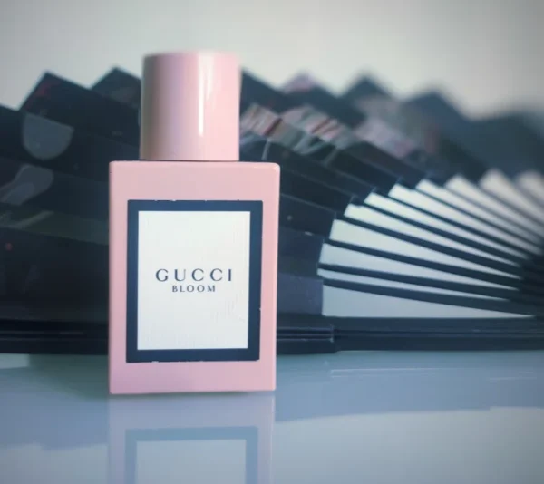 Side-by-side comparison of a $160 luxury white floral designer bottle versus a lab-direct Extrait de Parfum alternative crafted for long-lasting wear in the USA.