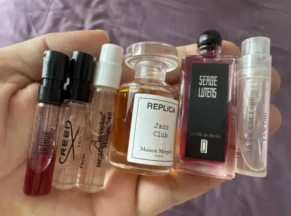 Side-by-side comparison of a traditional 300-dollar luxury designer perfume and a high-quality affordable replica cologne bottle.