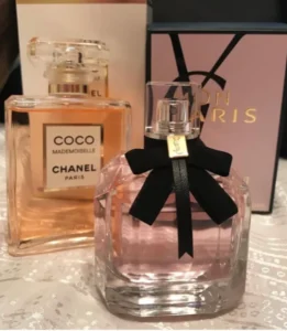 A side-by-side comparison of an expensive luxury designer perfume bottle and a highly concentrated, affordable YSL Mon Paris alternative by Imixx Perfumes.
