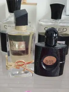 Visual comparison of a traditional high-end coffee vanilla fragrance bottle next to the minimalist Imixx Perfumes Extrait de Parfum.