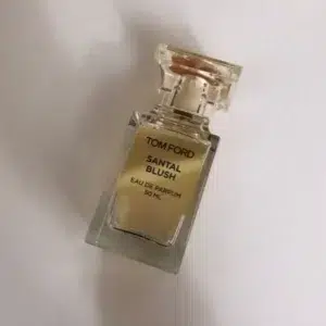 Luxury sandalwood perfume cost comparison showing an expensive designer bottle versus the direct-to-consumer iMixx Perfumes Santal Blush impression bottle.