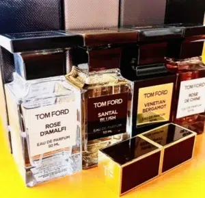 Side-by-side comparison of a $300 designer Tom Ford Santal Blush perfume bottle and a high-quality affordable creamy sandalwood fragrance alternative.