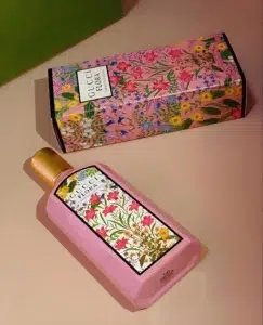 Side-by-side comparison of an authentic luxury Gucci Flora Gorgeous Gardenia bottle and a high-quality, long-lasting affordable perfume dupe alternative.