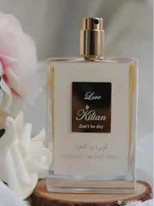 Side-by-side comparison of a luxury designer fragrance bottle and a high-quality Love Don't Be Shy dupe.