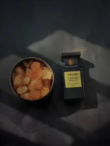 A $300 designer perfume bottle compared to an affordable, high-concentration spicy amber perfume alternative.